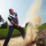 Samuel L. Jackson hits a golf shot out of a bunker