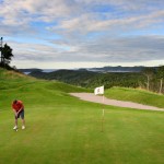 A man putting on the green at The View Golf Resort, Newfoundland.