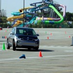 Rory McIlroy and Gary Woodland race in a BMW i3 prior to the 2013 BMW Championship at Conway Farms Golf Club in Illinois