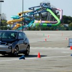 Rory McIlroy and Gary Woodland race in a BMW i3 prior to the 2013 BMW Championship at Conway Farms Golf Club in Illinois