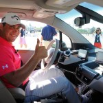 Rory McIlroy and Gary Woodland race in a BMW i3 prior to the 2013 BMW Championship at Conway Farms Golf Club in Illinois