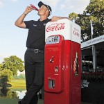 Henrik Stenson drinks a bottle of coke beside the trophy, a 1956 Vendo 44 machine, after winning the TOUR Championship and FedEx Cup