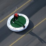 Tiger Woods in Turkey hitting a golf ball on the Bosphorus Bridge, which connects Europe and Asia